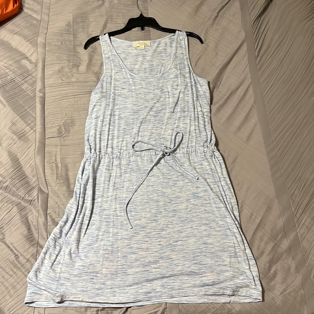 Olive and Oak soft blue dress with a tie in front and pocket on the top left.